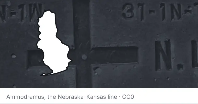 A survey monument's crosshair, under the outline of Baldwin County. The source names the Nebraska-Kansas line.
