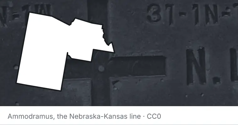 A survey monument's crosshair, under the outline of Maricopa County. The source names the Nebraska-Kansas line.