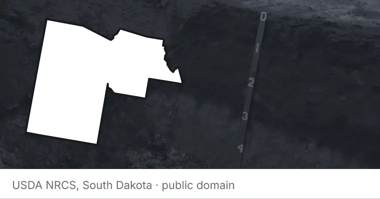 A soil profile in an open pit, under the outline of Maricopa County. The source names South Dakota.