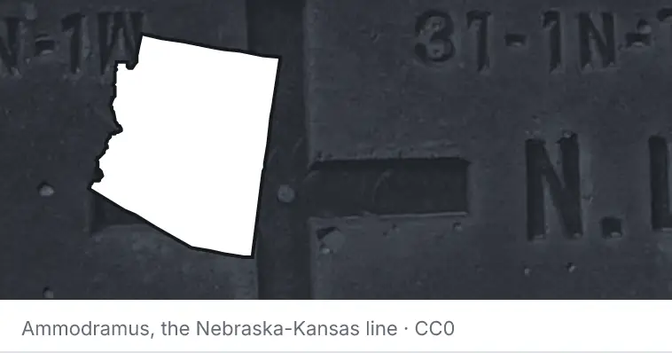 A survey monument's crosshair, under the outline of Arizona. The source names the Nebraska-Kansas line.