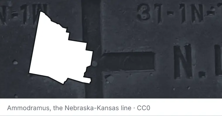 A survey monument's crosshair, under the outline of Yavapai County. The source names the Nebraska-Kansas line.