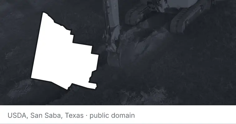 An excavator cutting a trench, under the outline of Yavapai County. The source names San Saba, Texas.