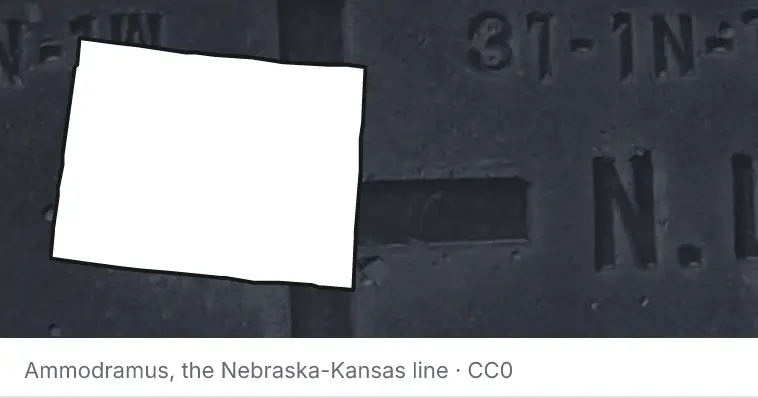 A survey monument's crosshair, under the outline of Colorado. The source names the Nebraska-Kansas line.