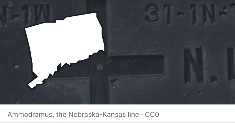 A survey monument's crosshair, under the outline of Connecticut. The source names the Nebraska-Kansas line.