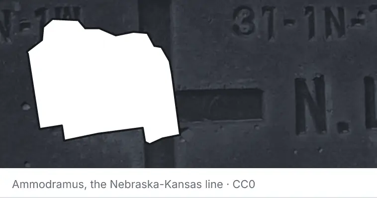A survey monument's crosshair, under the outline of Alachua County. The source names the Nebraska-Kansas line.