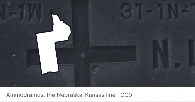A survey monument's crosshair, under the outline of Lake County. The source names the Nebraska-Kansas line.