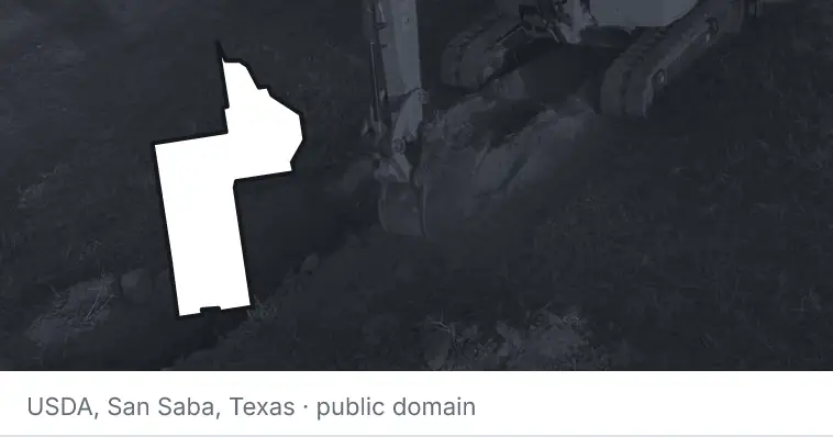 An excavator cutting a trench, under the outline of Lake County. The source names San Saba, Texas.