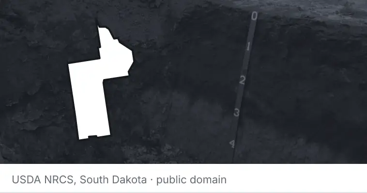 A soil profile in an open pit, under the outline of Lake County. The source names South Dakota.