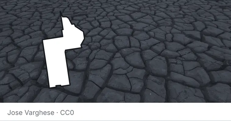 Dried, cracked ground, under the outline of Lake County.