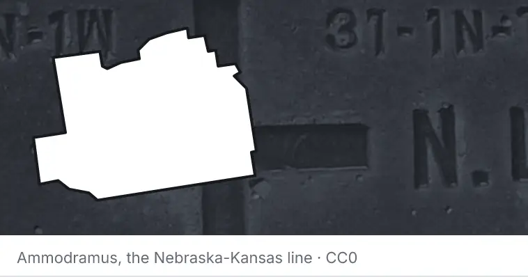 A survey monument's crosshair, under the outline of Marion County. The source names the Nebraska-Kansas line.