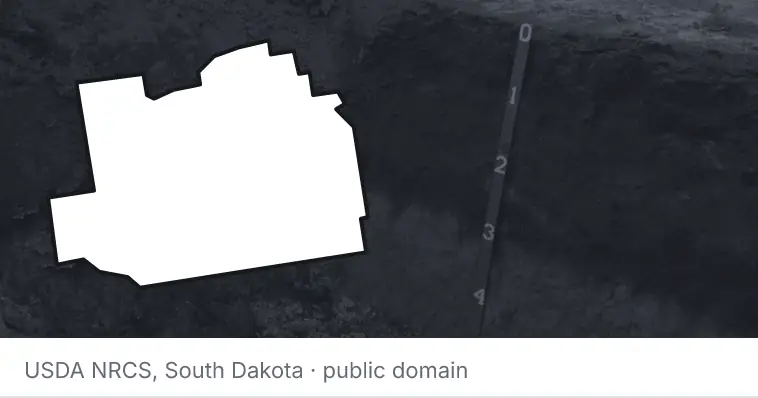 A soil profile in an open pit, under the outline of Marion County. The source names South Dakota.