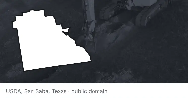 An excavator cutting a trench, under the outline of Polk County. The source names San Saba, Texas.