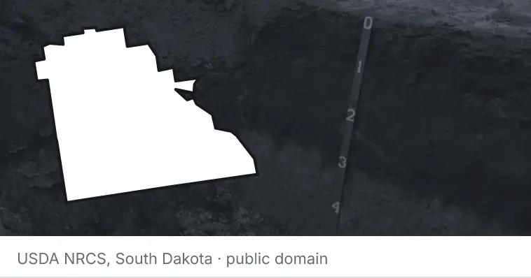 A soil profile in an open pit, under the outline of Polk County. The source names South Dakota.