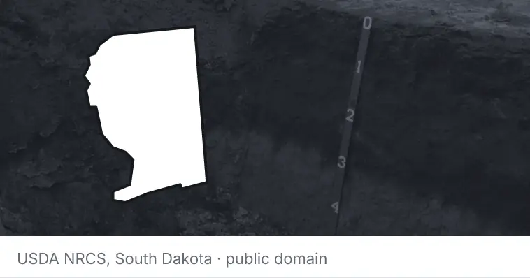 A soil profile in an open pit, under the outline of Santa Rosa County. The source names South Dakota.