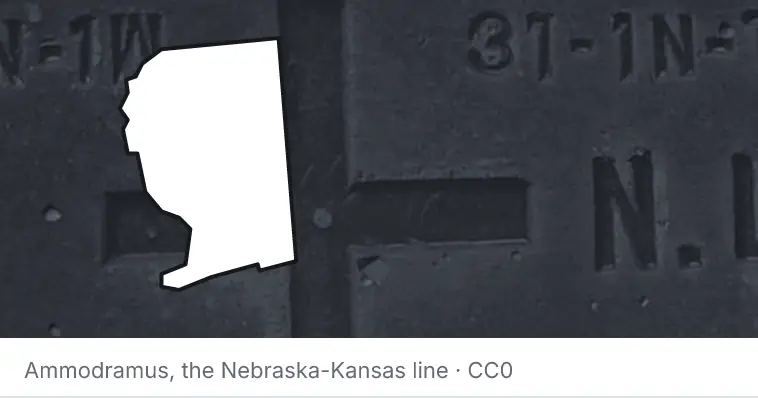 A survey monument's crosshair, under the outline of Santa Rosa County. The source names the Nebraska-Kansas line.