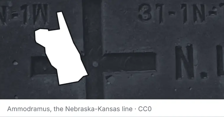 A survey monument's crosshair, under the outline of St. Johns County. The source names the Nebraska-Kansas line.