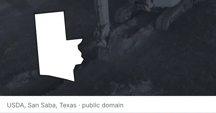 An excavator cutting a trench, under the outline of Walton County. The source names San Saba, Texas.