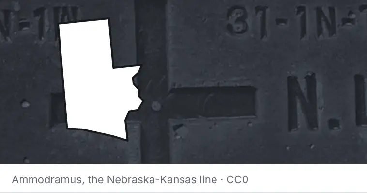 A survey monument's crosshair, under the outline of Walton County. The source names the Nebraska-Kansas line.