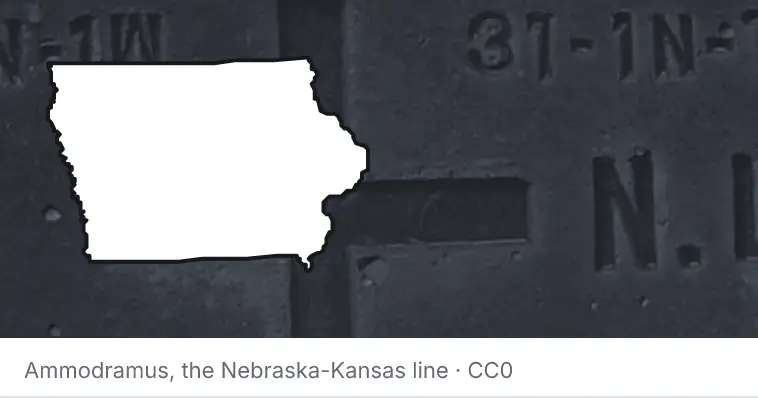A survey monument's crosshair, under the outline of Iowa. The source names the Nebraska-Kansas line.