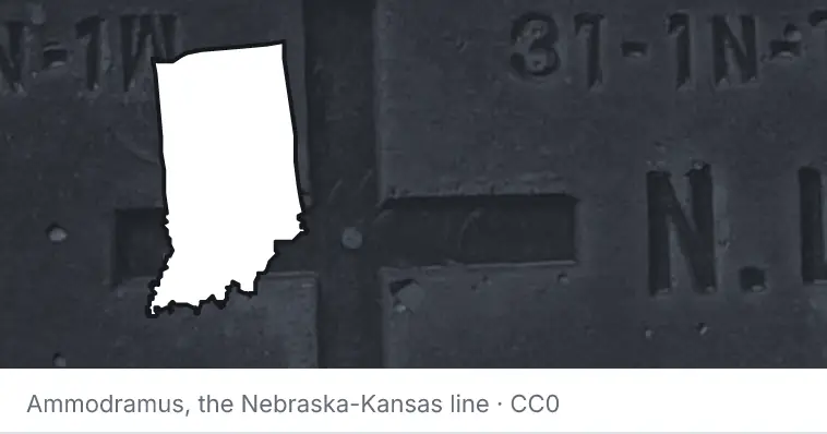 A survey monument's crosshair, under the outline of Indiana. The source names the Nebraska-Kansas line.