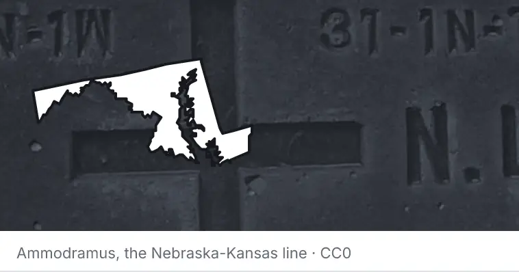 A survey monument's crosshair, under the outline of Maryland. The source names the Nebraska-Kansas line.