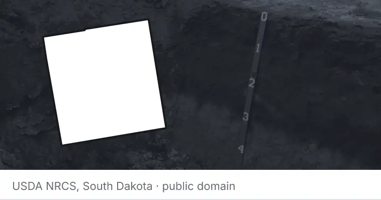 A soil profile in an open pit, under the outline of Oakland County. The source names South Dakota.