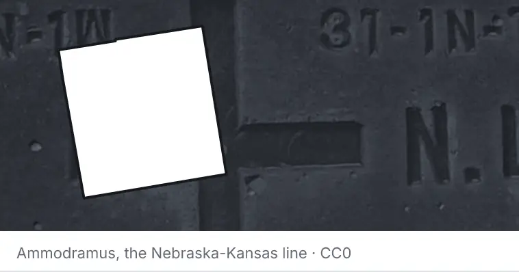 A survey monument's crosshair, under the outline of Oakland County. The source names the Nebraska-Kansas line.