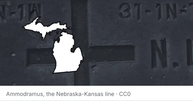 A survey monument's crosshair, under the outline of Michigan. The source names the Nebraska-Kansas line.
