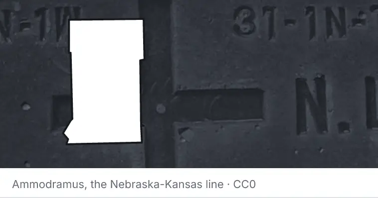 A survey monument's crosshair, under the outline of Crow Wing County. The source names the Nebraska-Kansas line.