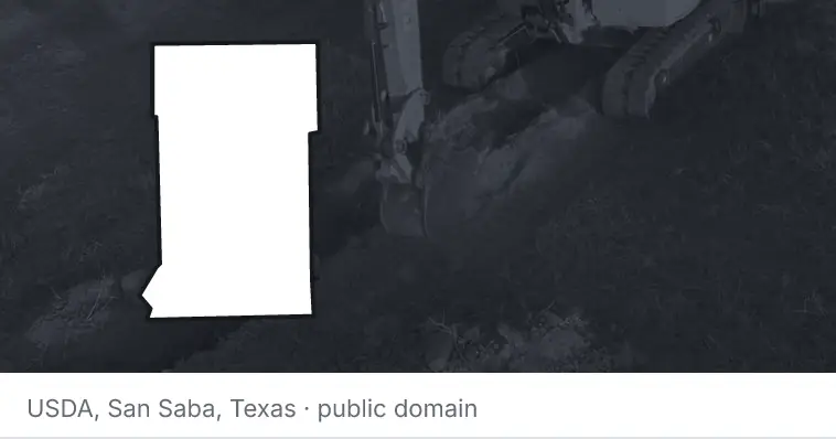 An excavator cutting a trench, under the outline of Crow Wing County. The source names San Saba, Texas.