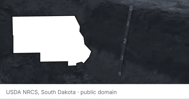 A soil profile in an open pit, under the outline of Stearns County. The source names South Dakota.