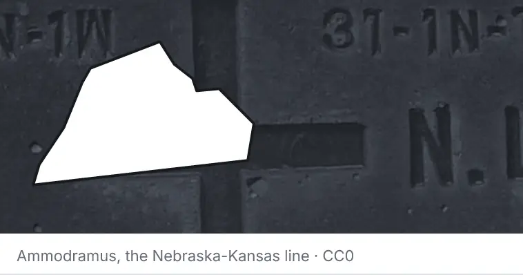 A survey monument's crosshair, under the outline of Catawba County. The source names the Nebraska-Kansas line.