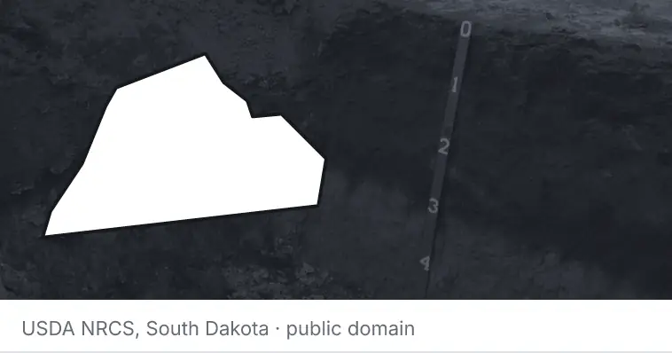 A soil profile in an open pit, under the outline of Catawba County. The source names South Dakota.