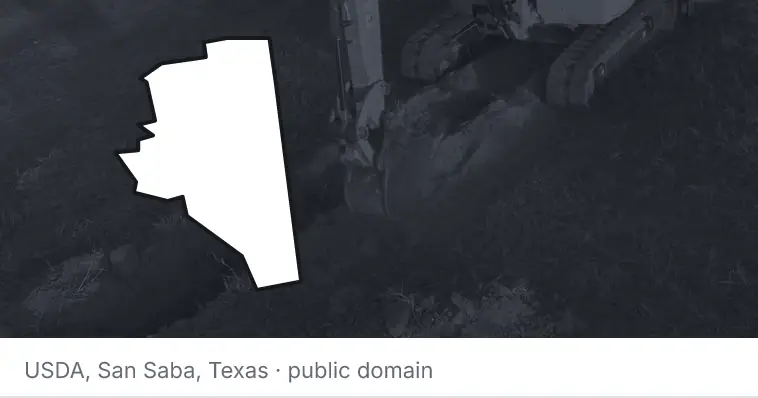 An excavator cutting a trench, under the outline of Davidson County. The source names San Saba, Texas.