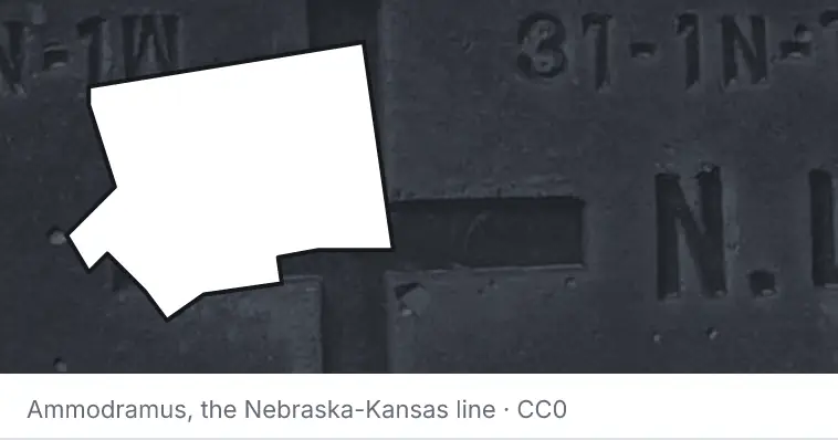 A survey monument's crosshair, under the outline of Forsyth County. The source names the Nebraska-Kansas line.
