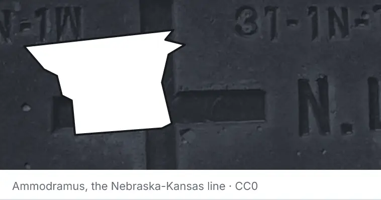 A survey monument's crosshair, under the outline of Gaston County. The source names the Nebraska-Kansas line.