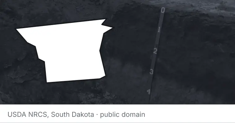 A soil profile in an open pit, under the outline of Gaston County. The source names South Dakota.