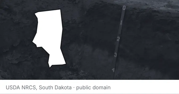A soil profile in an open pit, under the outline of Iredell County. The source names South Dakota.