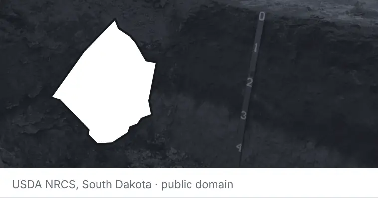 A soil profile in an open pit, under the outline of Johnston County. The source names South Dakota.