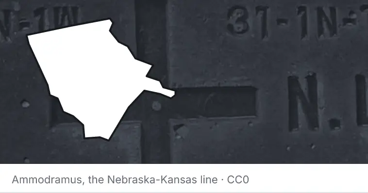 A survey monument's crosshair, under the outline of Moore County. The source names the Nebraska-Kansas line.