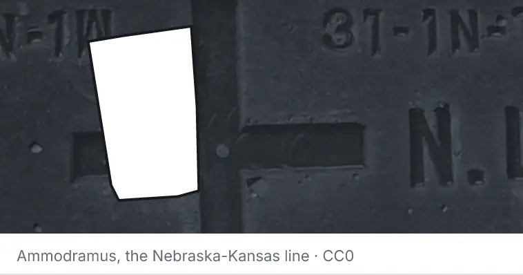 A survey monument's crosshair, under the outline of Orange County. The source names the Nebraska-Kansas line.