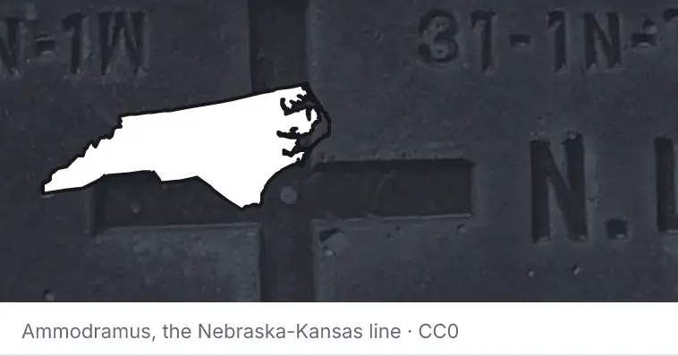A survey monument's crosshair, under the outline of North Carolina. The source names the Nebraska-Kansas line.