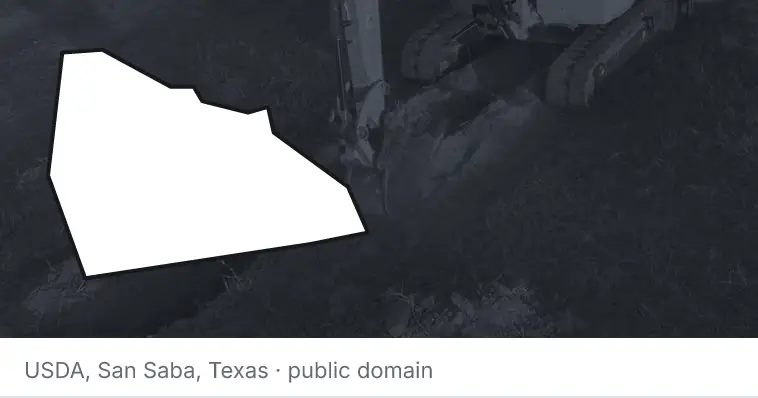 An excavator cutting a trench, under the outline of Rowan County. The source names San Saba, Texas.