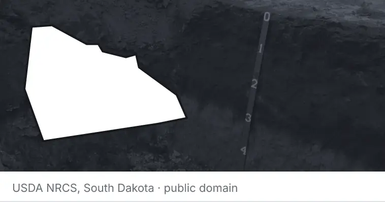 A soil profile in an open pit, under the outline of Rowan County. The source names South Dakota.