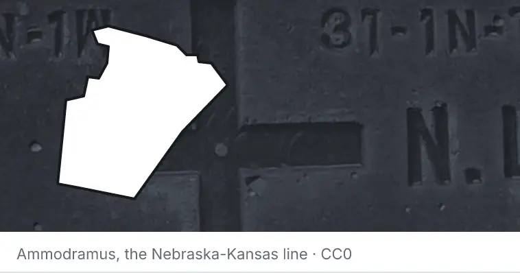 A survey monument's crosshair, under the outline of Wake County. The source names the Nebraska-Kansas line.