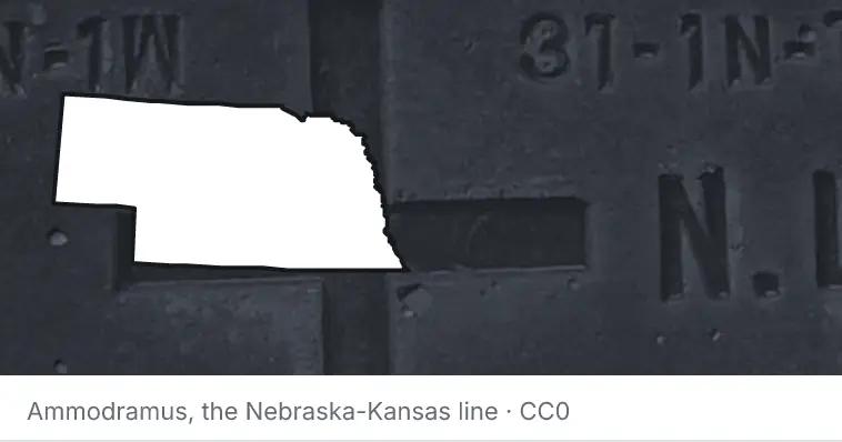 A survey monument's crosshair, under the outline of Nebraska. The source names the Nebraska-Kansas line.