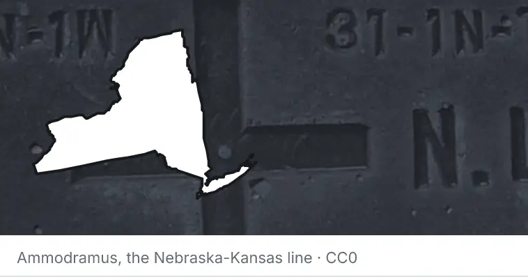 A survey monument's crosshair, under the outline of New York. The source names the Nebraska-Kansas line.