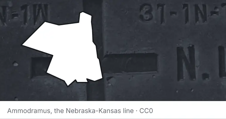 A survey monument's crosshair, under the outline of Ulster County. The source names the Nebraska-Kansas line.