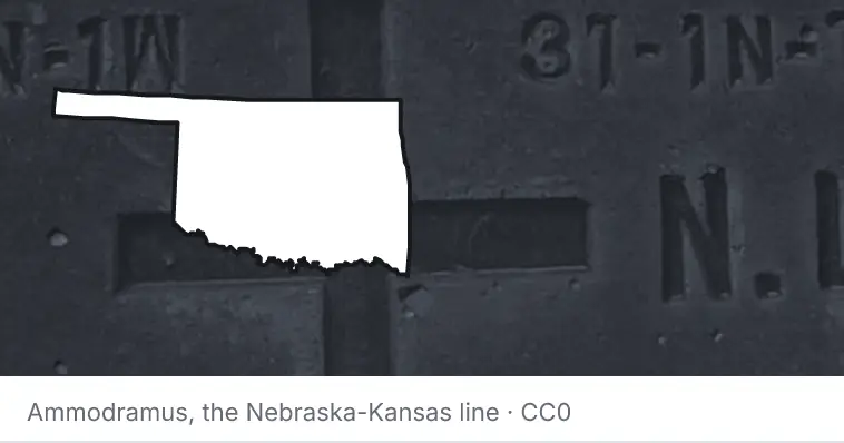 A survey monument's crosshair, under the outline of Oklahoma. The source names the Nebraska-Kansas line.
