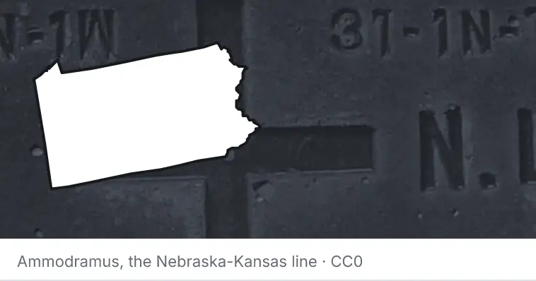 A survey monument's crosshair, under the outline of Pennsylvania. The source names the Nebraska-Kansas line.